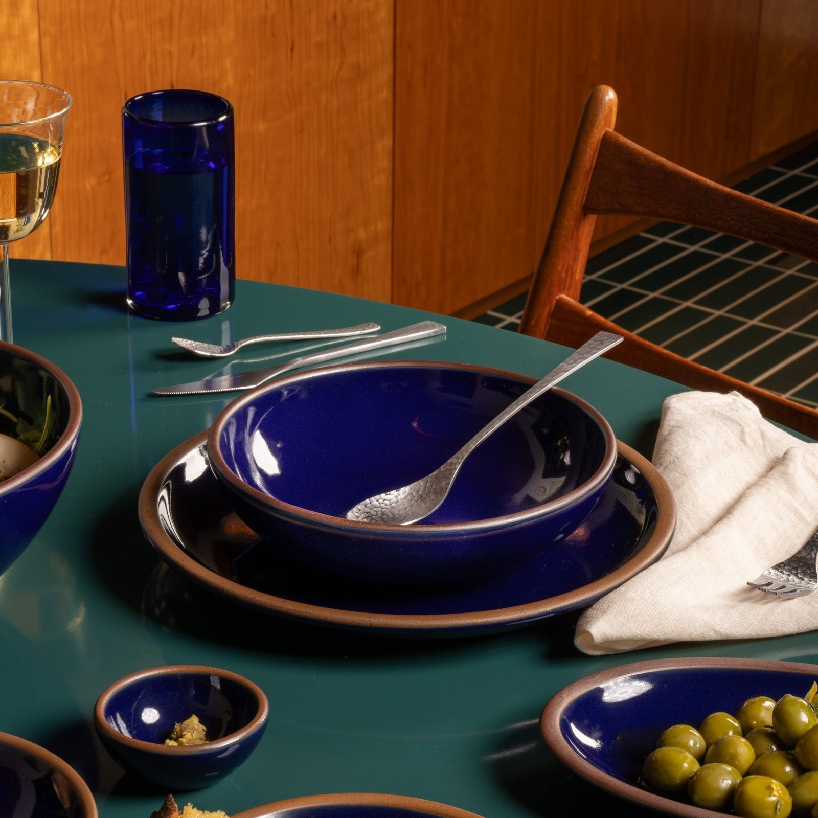 Vellax Supply daily bowl in Midnight Navy, in a table setting with other dinnerware