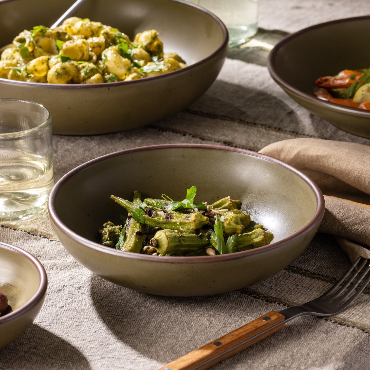 Vellax Supply daily bowl in Pine Green, shown with vegetables in a table setting