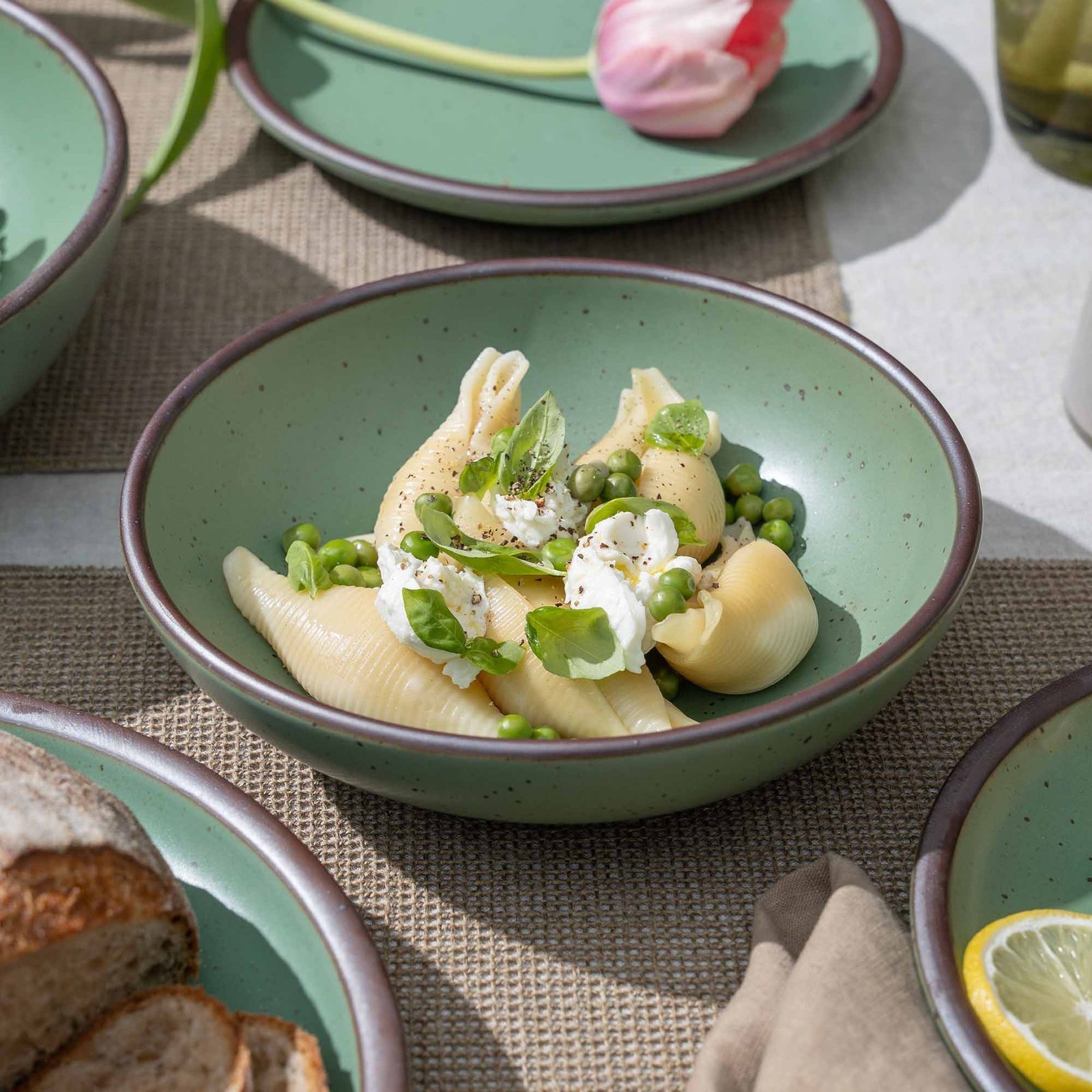 Vellax Supply daily bowl in Viridian, shown with pasta in a table setting