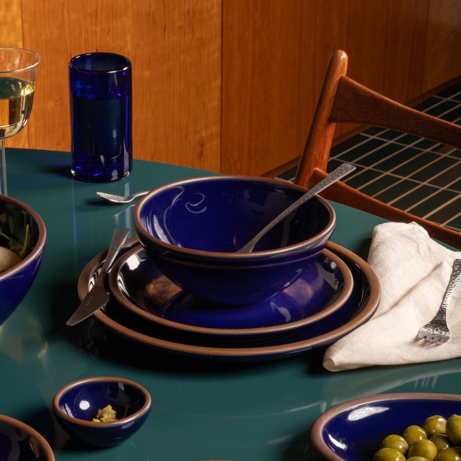 Vellax Supply soup bowl in Midnight Navy, in a table setting with other dinnerware