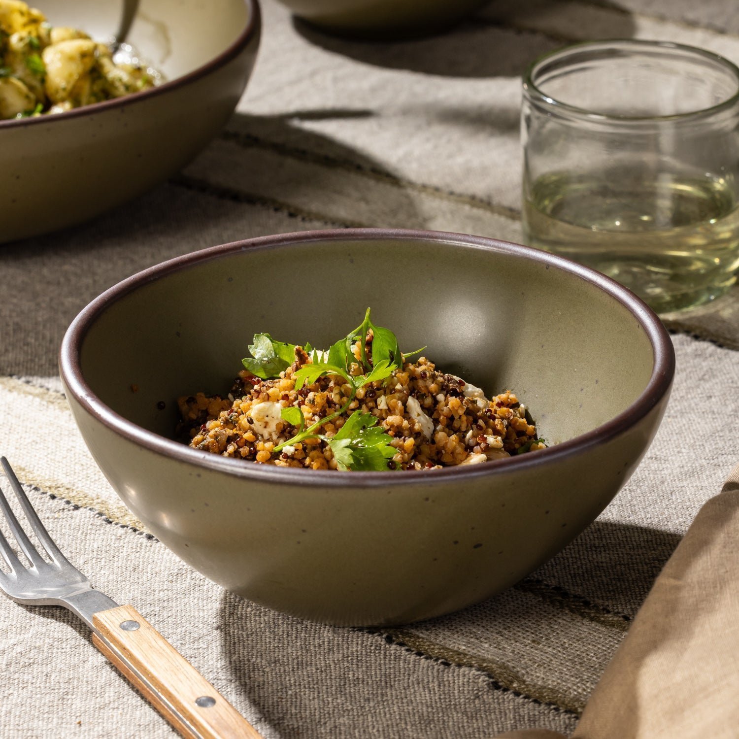 Vellax Supply soup bowl in Pine Green, shown with a grain dish